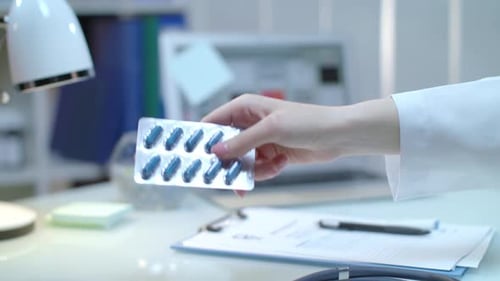 Doctor giving medicine tablet prescription to patient in hospital healthcare treatment