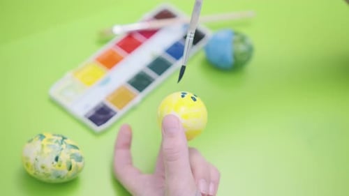Painting Easter Egg with Brush Close Up