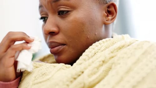 Sick Woman with a Cold Using a Tissue