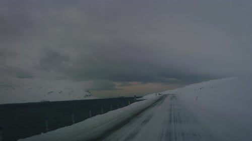 Empty Arctic highway in Iceland surrounded by icy wilderness in winter