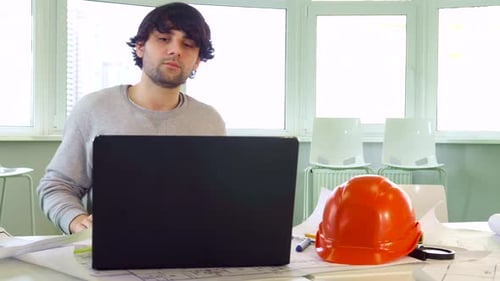 Architect Closes the Laptop at the Office