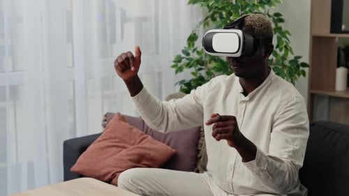 Young Adult Using VR Headset in Living Room
