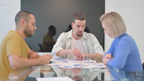 Business Meeting With Charts and Graphs