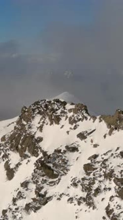 Snowy Mountain Peak With Low Clouds. British Columbia, Canada.