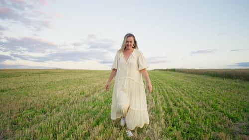 The Mowed Wheat Field Becomes a Place for a Woman to Run Freely