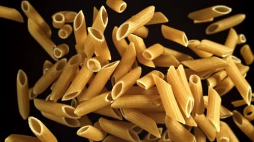 Penne Pasta Falling Slowly in a Dark Void