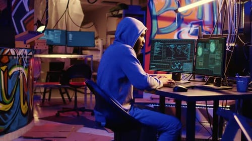 Hooded Hacker Doing Computer Sabotage