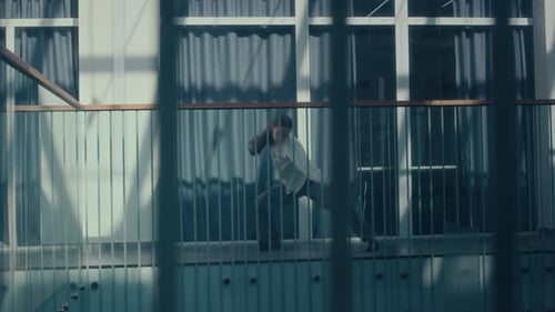 Female Office Worker in White Shirt Performing Bizarre Dance in Workspace