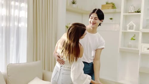 Couple Slow Dancing in Bright Home Sunlight