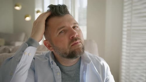 Stylish Man Grooms Hair Indoors