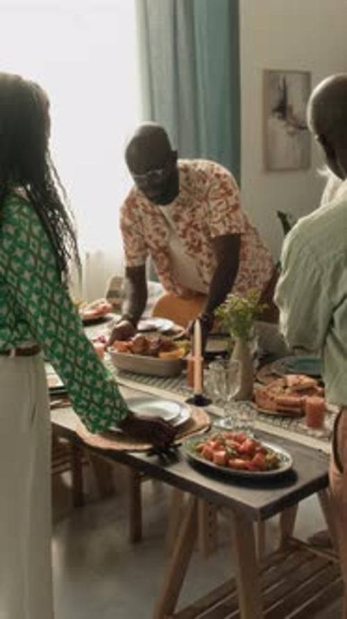 Friends and Family Preparing Meal Together at Home