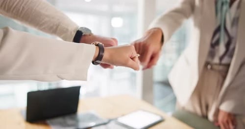 Fist bump, hands and teamwork with business people in office together for solidarity or unity