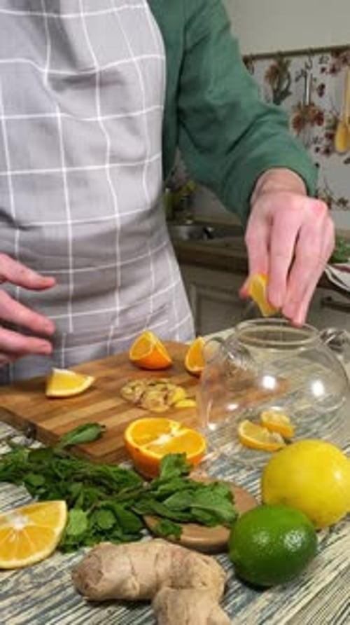 Making citrus hot beverage at domestic kitchen