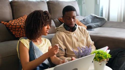 Friends Working Together on Laptop at Home