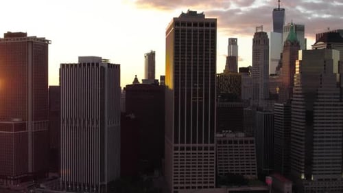 Tall skyscrapers in Manhattan, backlit by the sunset in New York, USA - Aerial view