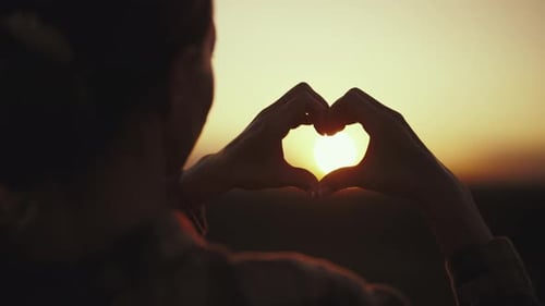 Woman Folding Hands at Sunset in Heart Shape Symbol of Real Romantic Love Back View Healthy