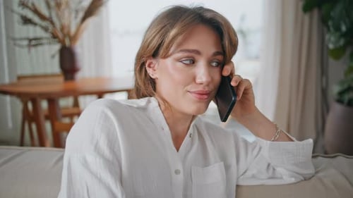 Woman Talking on Phone Inside Bright Modern Apartment