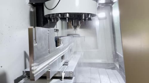 Aluminum Parts Being Fabricated On An Automated CNC Close Up Shot.