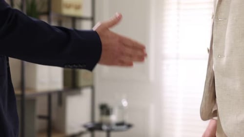 Business Handshake Between Two Men in a Home Office