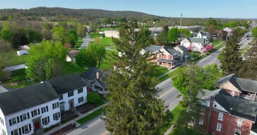 Scenic Drone Flight Over Small Town Houses And Rolling Hills