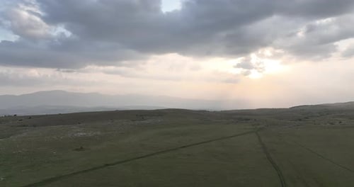 Aerial Shot of Meadows Covered with Soft Mist on a Cloudy Day in the Countryside