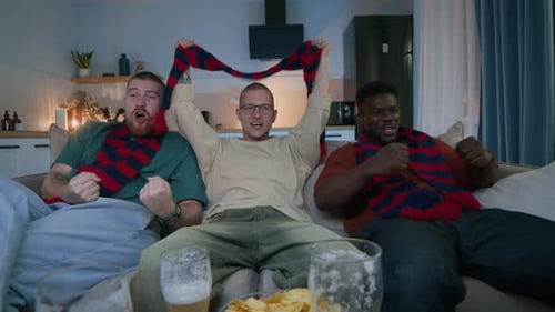 Enthusiastic Friends Cheer Watching Sports at Home