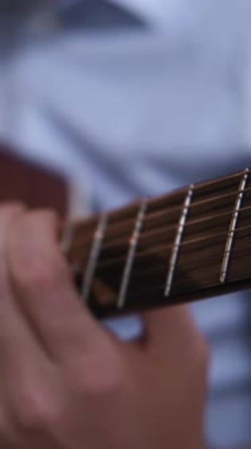 Close up of Hands Playing Acoustic Guitar