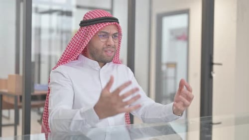 Upset Arab Man Sitting Tense in Office