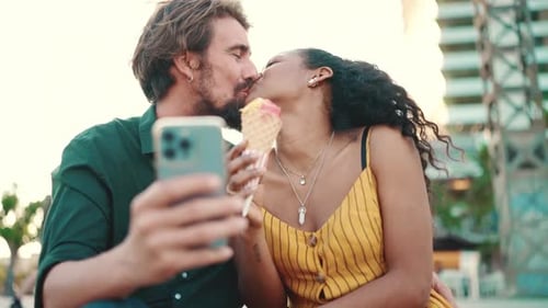 Close up of happy man and smiling woman watching video on smartphone