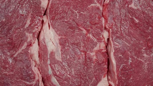 Steak Meat Rotating Background. Raw Beef Ribeye Close Up Video Backdrop. Food Concept