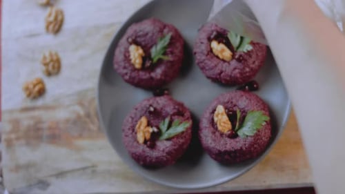 Purple food patties with walnuts and berries