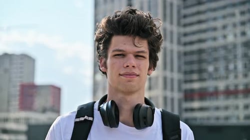 Young Man with Headphones Posing in City