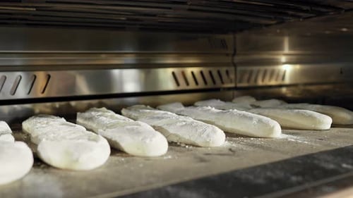 Close Up of Baguettes Being Baking in Oven Fresh Bread in Bakery is Cooking in the Morning Inside
