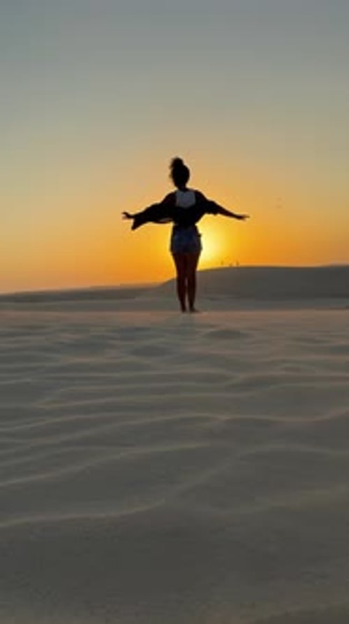 Woman Enjoying Sunset on Sand Dune