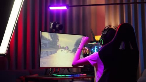 Female Young Adult Playing Video Game at Night