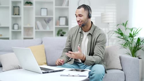 Man Talking on a Laptop Video Call at Home