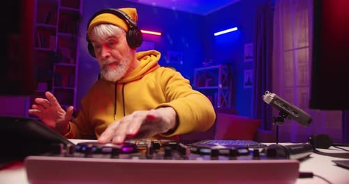 Close Up of Stylish Caucasian Funny Happy Pensioner Man Playing Music at Home Recording Studio