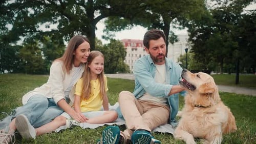 Family and Dog Relaxing in the Park