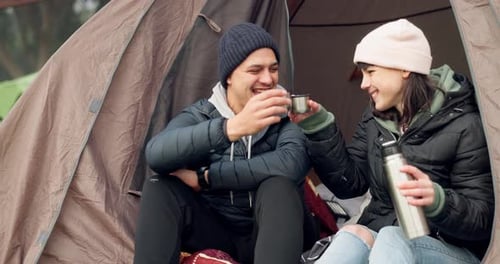 Couple Drinking Hot Beverage Inside Tent