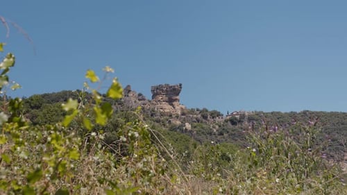 Beautiful remote rock and green surroundings in France, static distance view