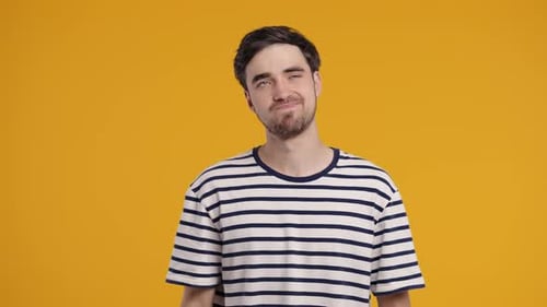 Man Rolling Eyes on Yellow Background