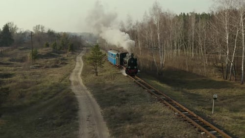 Aerial View of Old Steam Train Running on the Tracks in the Countryside