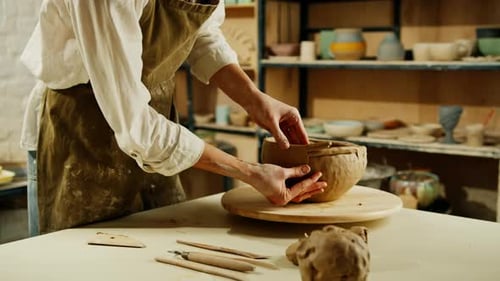 Creating handicraft pottery closeup of working table in ceramics studio with female master