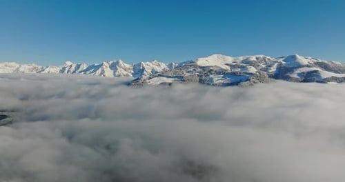 Aerial View Of Mountain Peaks Sticking Above The Clouds