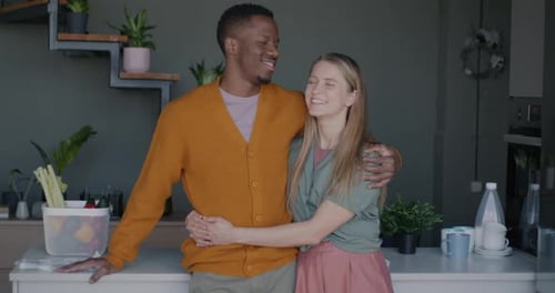 Affectionate Couple Embracing in Bright Kitchen
