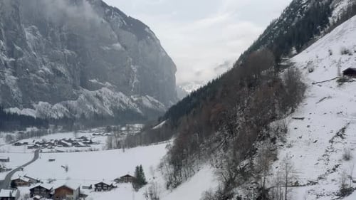 Drone Aerial of Lauterbrunnen surrounded by the Mountain Eiger in the swiss alps. The winter in Swit