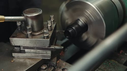 Close-up shot of processing and turning of a plastic workpiece on a lathe