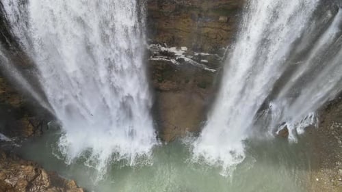 Aerial View of Powerful Waterfall Cascading Down