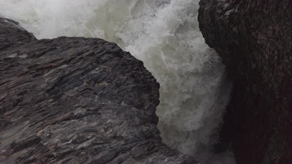 Water converging flowing trough rocks river, waves, close up , Alberta ...
