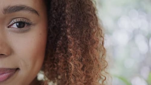Woman Smiling With Curly Hair in Extreme Close Up